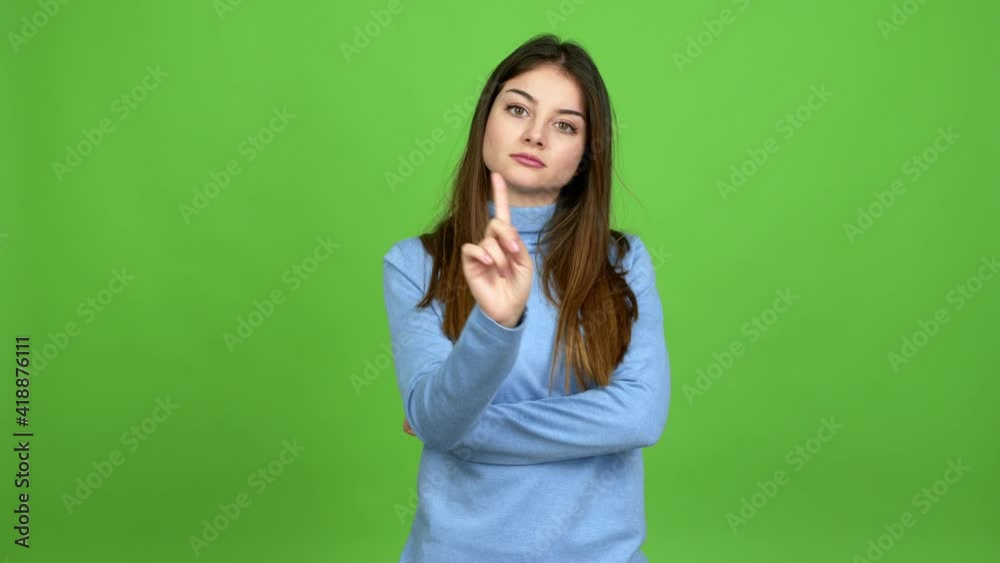 Young caucasian woman doing NO gesture over isolated background. Green screen chroma key Young caucasian woman doing NO gesture over isolated background. Green screen chroma key