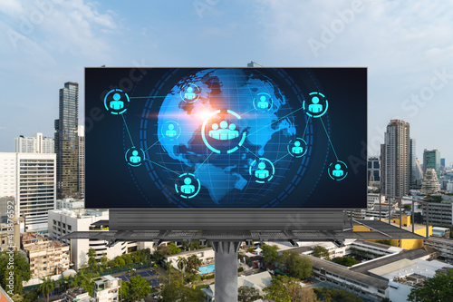 World planet Earth map hologram and social media icons on billboard over panorama city view of Bangkok, Southeast Asia. The concept of people networking and connections.