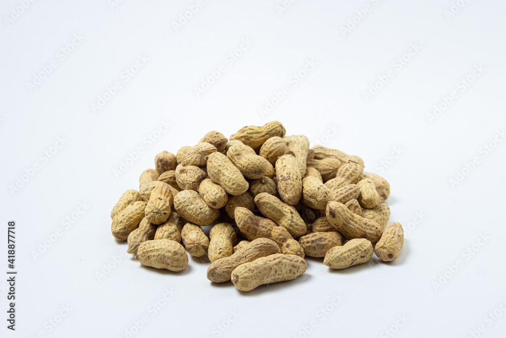 Peanuts on a white background. A small pile of peanuts. Peanuts in shell Peanuts on a white background. A small pile of peanuts. Peanuts in shell