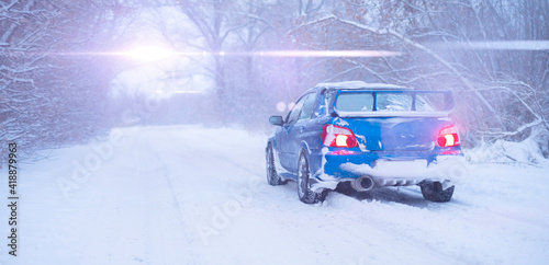 fast blue sport car on winter snowy day, cold season, street road © Mihail