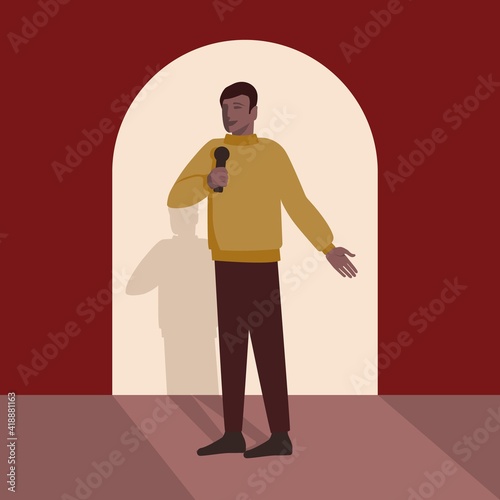 Man with microphone makes speech on stage