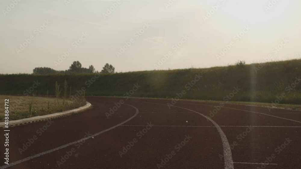 Shot of a man in the running start position then running, on a athletic lane track. Shot of a man in the running start position then running, on a athletic lane track.