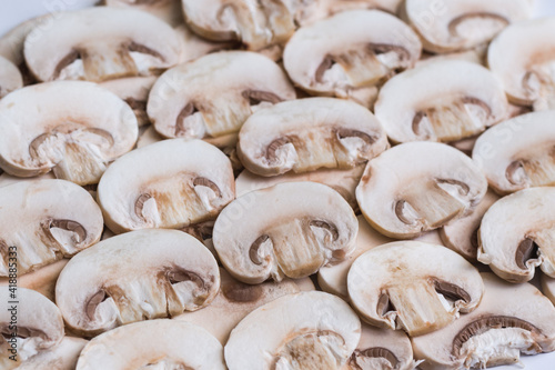 Young mushrooms champignons, sliced into plates, close-up, background, selective focus