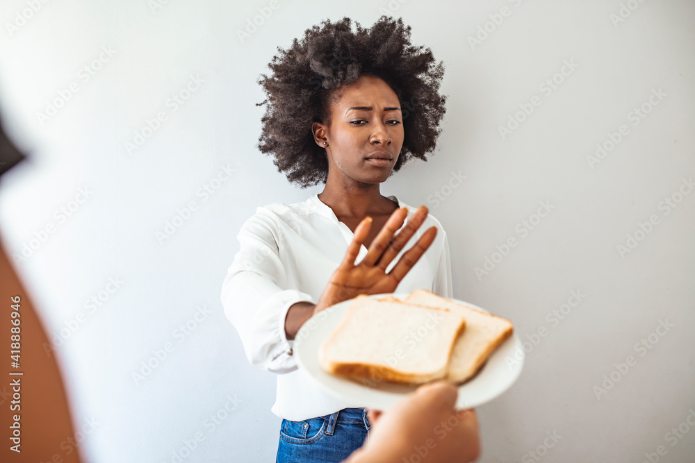 Gluten intolerance concept. Young girl refuses to eat white bread
