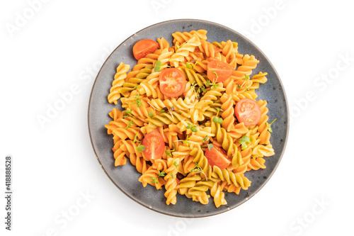 Tortiglioni semolina pasta with tomato and microgreen sprouts isolated on white background. Top view, close up.