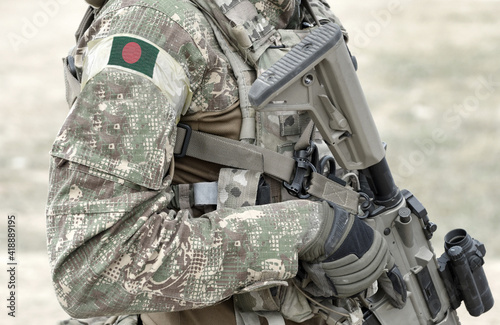 Obraz na plátně Soldier with assault rifle and flag of Bangladesh on military uniform