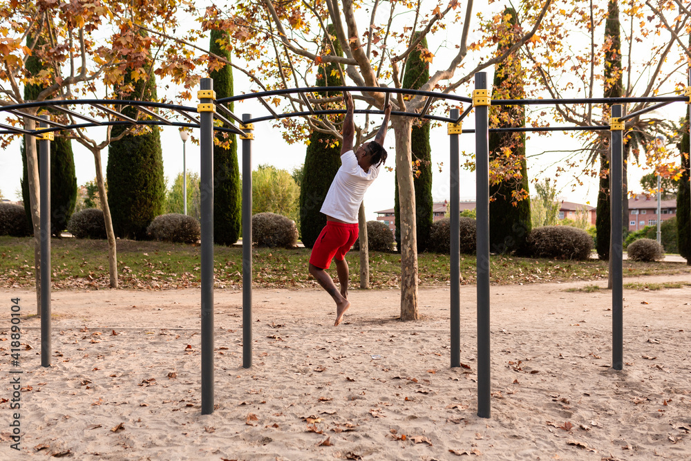 african american athlete doing fitness exercises on bars, calisthenics workout. african american athlete doing fitness exercises on bars, calisthenics workout.