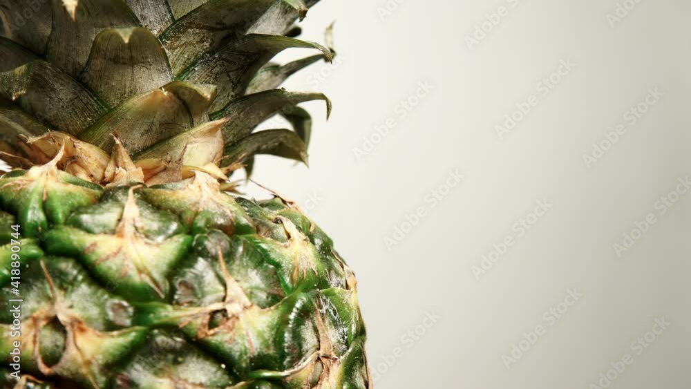 Close up of fresh whole pineapple ananas fruit rotating. Healthy eating.