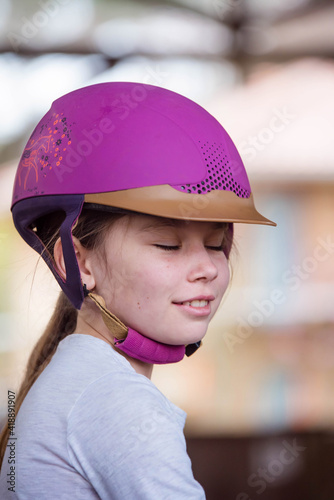 gorgeous face of a young girl riding a pony