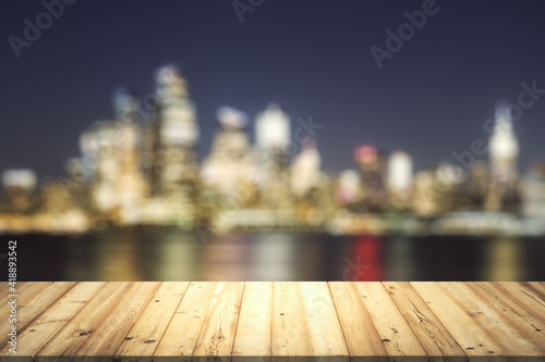 Table top made of wooden dies with blurry city view at dusk on background, template