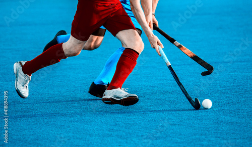 Photography Close up of two field hockey players, challenging eachother for