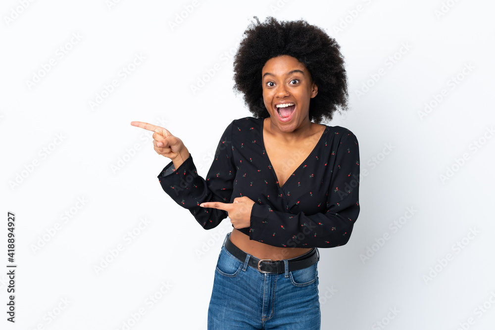 Young African American woman isolated on white background surprised and pointing side Young African American woman isolated on white background surprised and pointing side