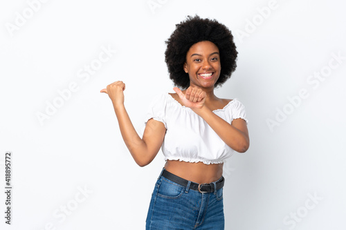 Young African American woman isolated on white background pointing to the side to present a product