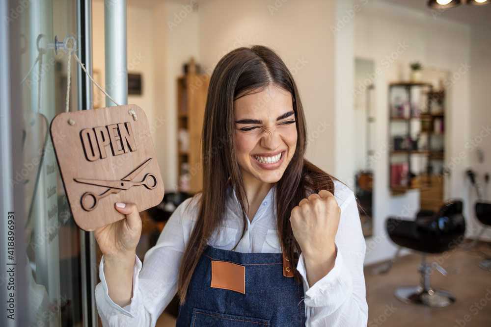 Young woman opening a beauty store and looking very happy - small ...