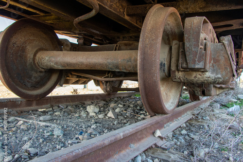 Industrial rail car wheels closeup photo. Old rusty train wheels. Wheel train system on track.