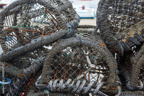 close up of a collection of lobster pots on the harbour