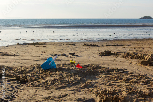 Children's buckets discarded on the sand 