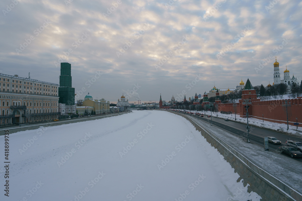 Moscow cityscape in the winter day. Red Kremlin Towers, Cathedral of Christ the Saviour, Red Kremlin Towers, Moskva River, Ivan the Great Bell Tower, Dormition Cathedral, traffic at the embankment
