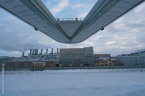 Photography of Moscow cityscape after snowstorm. Observation deck in Zaryadye park. Lifestyle during coronavirus pandemic. Soft white snow covering ground. Chmneys of Power Station. Raushskaya emb.