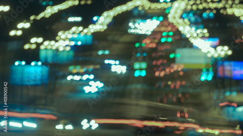 Long exposure photography of big urban night traffic. The lights of blurred motion at the highway. The road is filled out cars. White and blue colors of the headlamps.