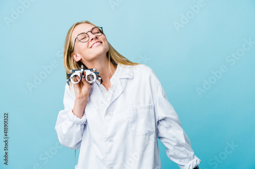 Young russian optometrist woman on blue dancing and having fun.