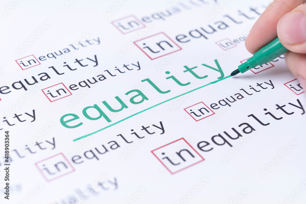 Hand underlines the word EQUALITY, gender equality concept. Selective focus Hand underlines the word EQUALITY, gender equality concept. Selective focus