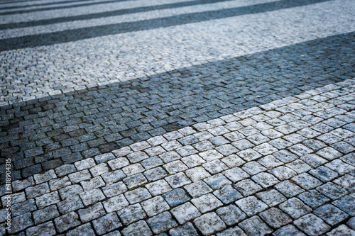 Diagonal lines of black and white cobblestone pavement photo