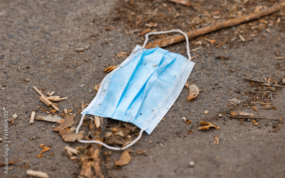 Discarded medical mask on the ground Discarded medical mask on the ground