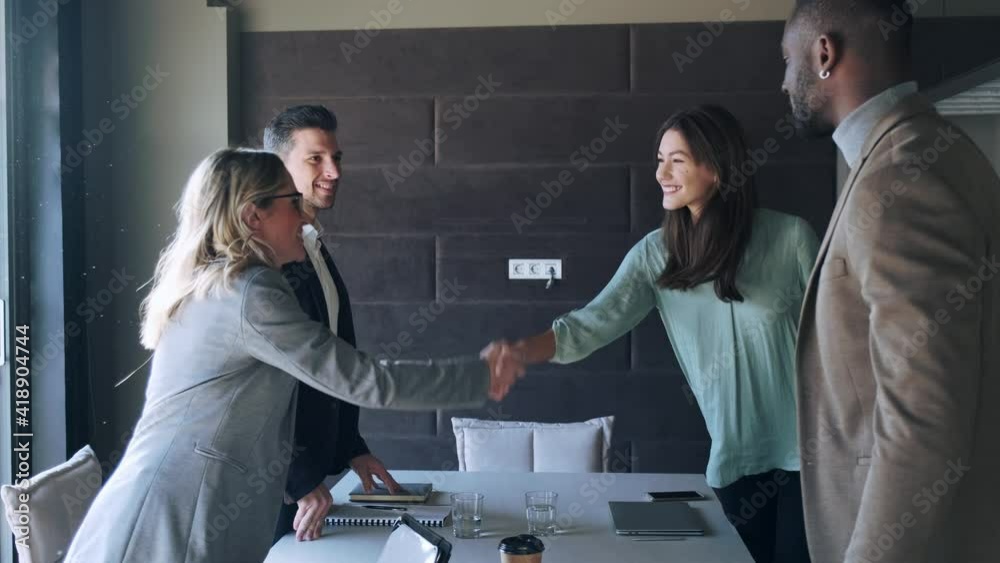 Business partners shaking hands after successful meeting