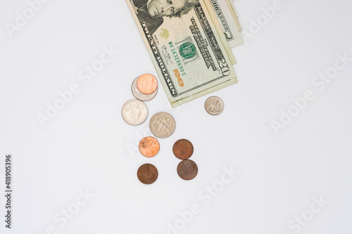 Dollar bills and coins on the white background photo