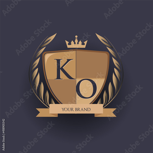 initial letter KO logotype colored brown and gold isolated with shield, crown and laurel design, logo for college and sport club.