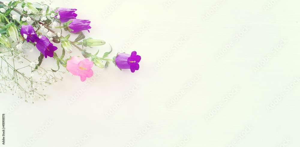 spring bouquet of purple, white and pink bell flowers over white wooden background
spring bouquet of purple, white and pink bell flowers over white wooden background