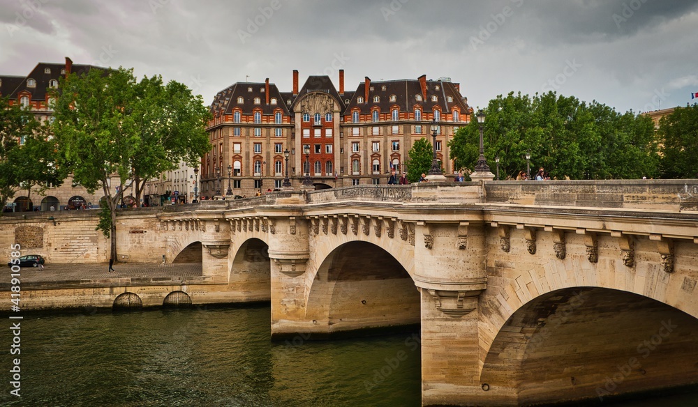 view of the Pont Neuf, bridge which crosses the River Seine from right bank of the Seine River in Paris, France
