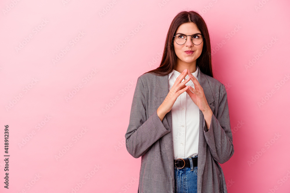 Young caucasian business woman isolated on pink background making up plan in mind, setting up an idea. Young caucasian business woman isolated on pink background making up plan in mind, setting up an idea.