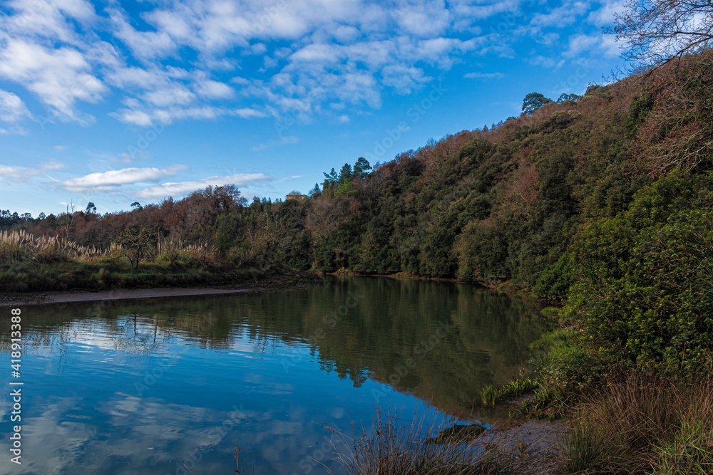 tranquil river in vizcaya in spainwith some clouds in the sky