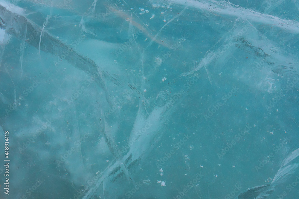 Fototapeta premium Turquoise ice of frozen river, background