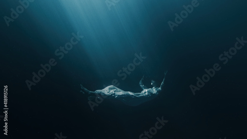 Fotografiet Silhouette Of Depressed Woman Sinking Into Underwater Grave Dark Deep Magic Ocea