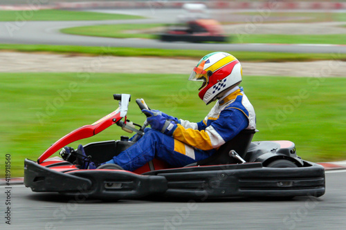 go-cart speeding along a race course . Motion blur in asphalt to emphasize speed.