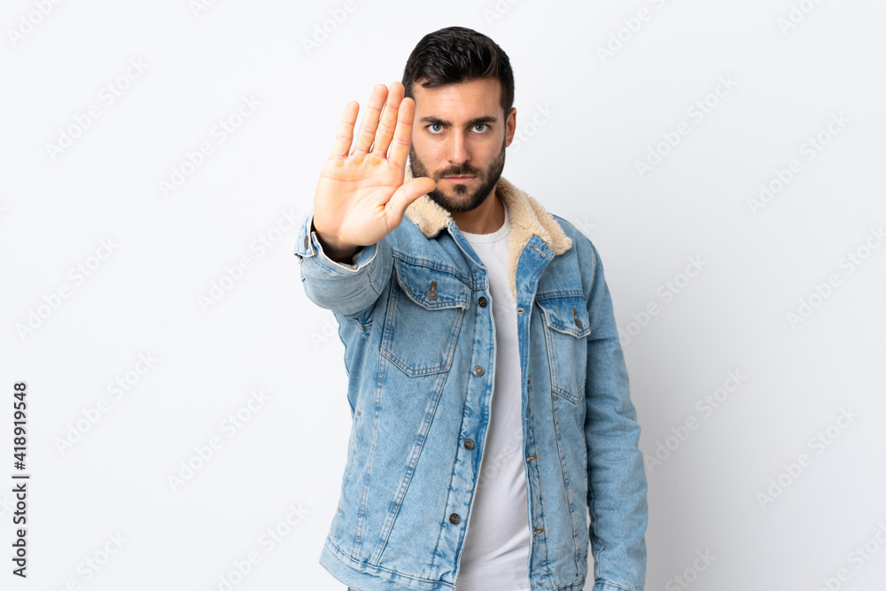 Young handsome man with beard isolated on white background making stop gesture Young handsome man with beard isolated on white background making stop gesture