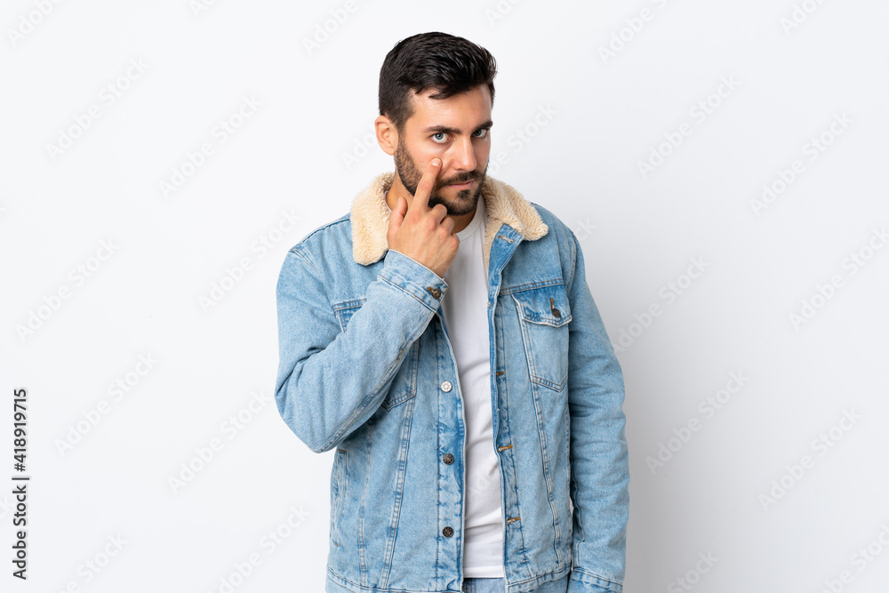 Young handsome man with beard isolated on white background showing something Young handsome man with beard isolated on white background showing something