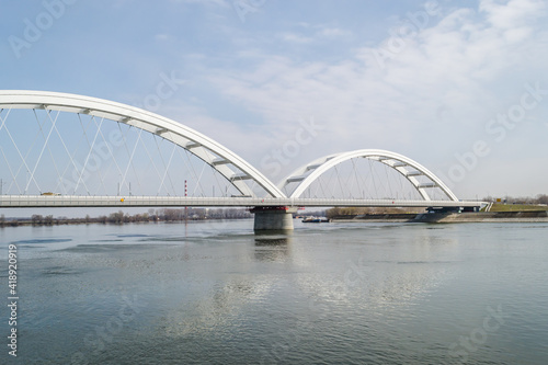 Novi Sad, Serbia - March 08. 2021: Zezelj bridge on river Danube in Novi Sad Serbia. The prospect of built New Zezelj Bridge viewed from the Petrovaradin side of the promenade. © caocao191