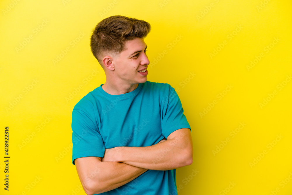 Young caucasian man isolated on yellow background laughing and having fun. Young caucasian man isolated on yellow background laughing and having fun.