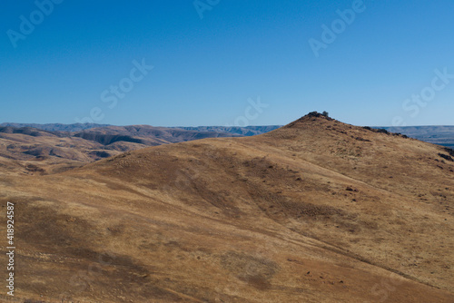 Desert hill in in front of vast desert landscape 