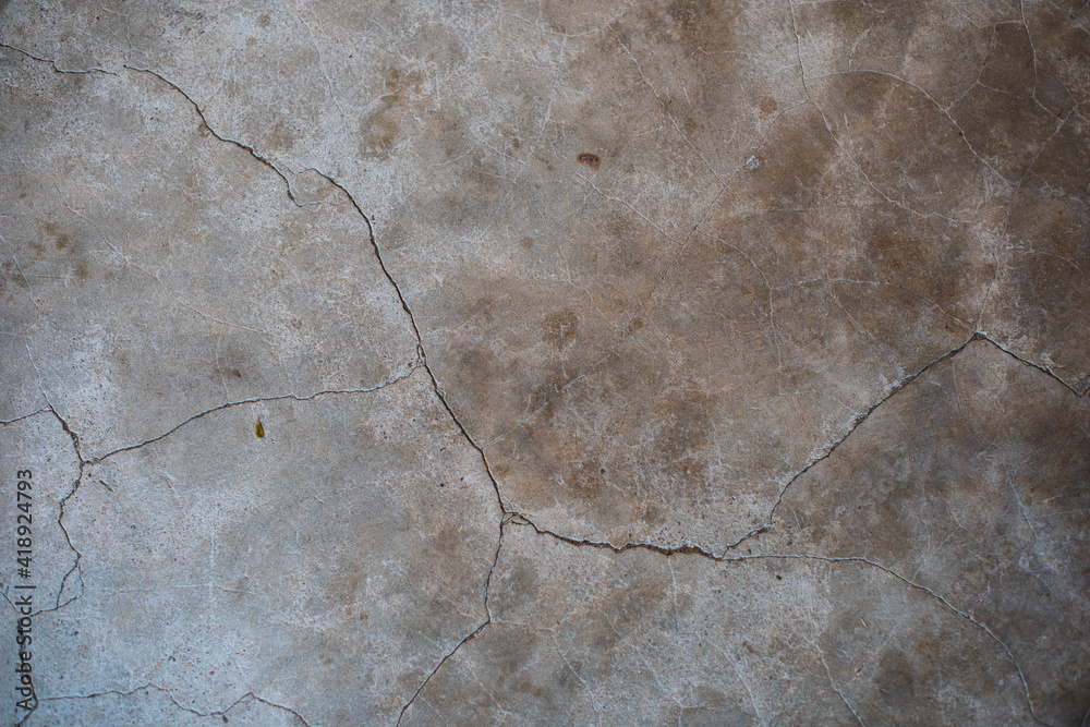 Close up look of rustic cracking cement wall with stains.