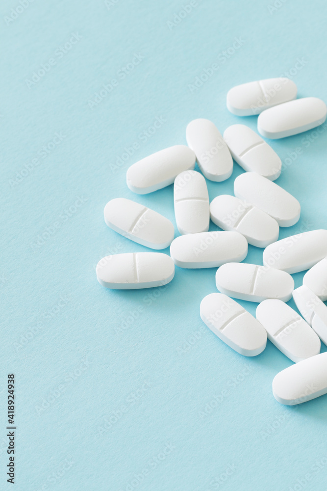 lot of medicine pills on blue background