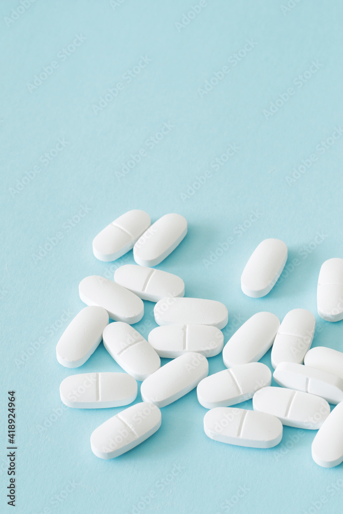 lot of medicine pills on blue background