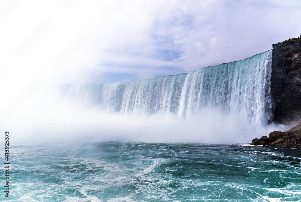 dramatic and spectacular image of the Niagara Falls taken during summer.
