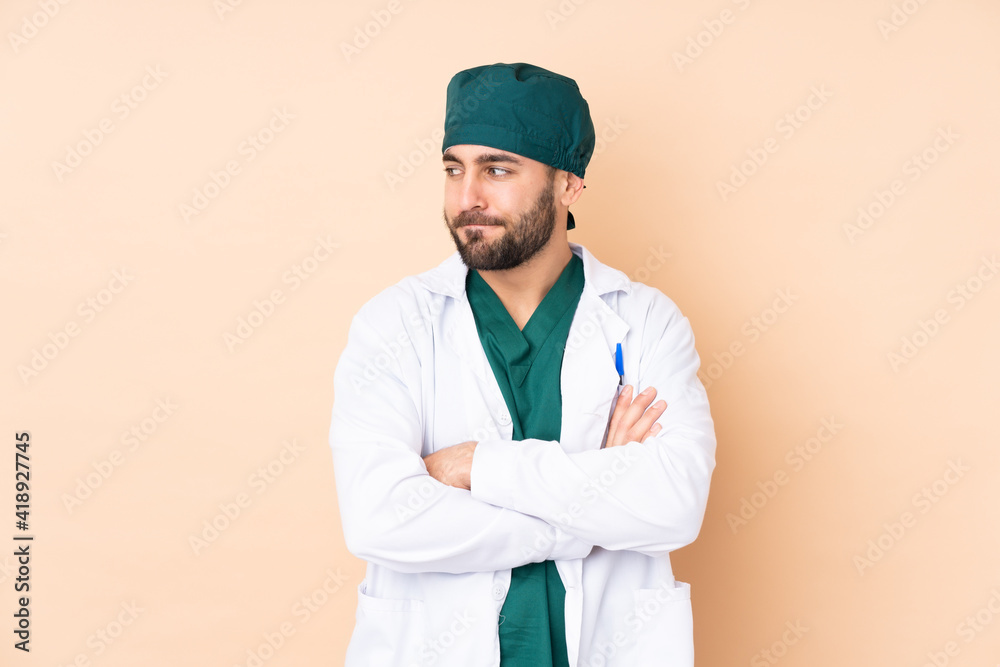 Surgeon man isolated on beige background thinking an idea Surgeon man isolated on beige background thinking an idea