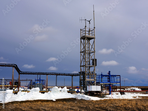 Ecology. Gas industry. Beautiful white clouds on a background of a gas well