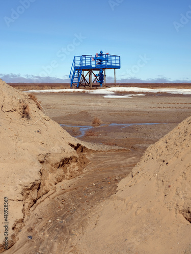 Ecology. Gas industry. Exploration well among sand and snow